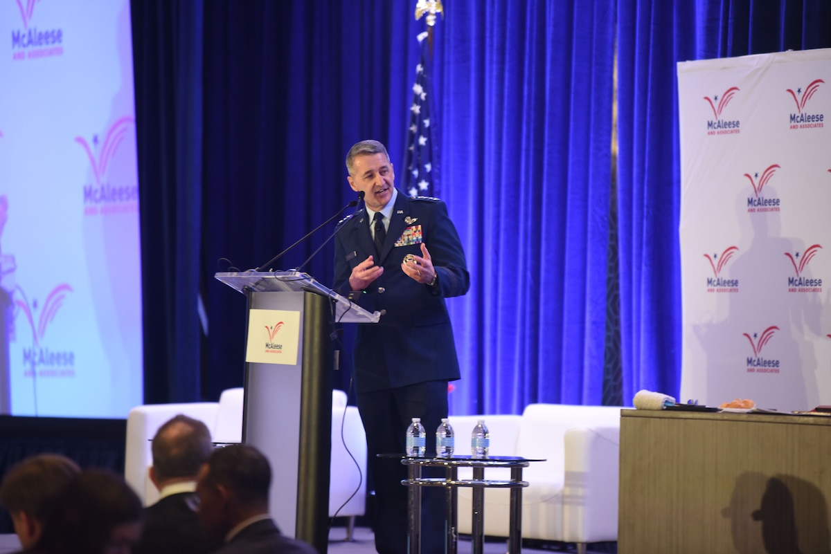 A man wearing a military uniform speaks at a podium.