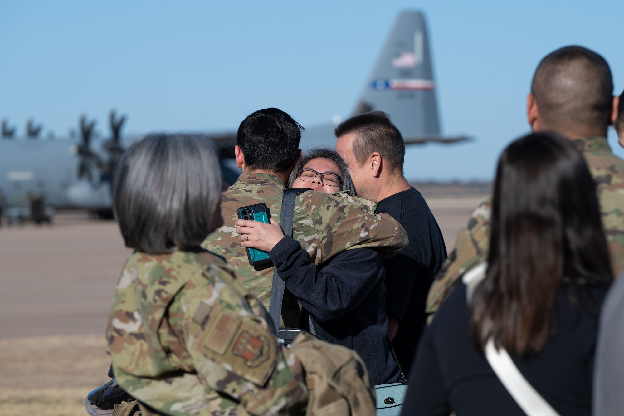 An Airman assigned to the 317th Airlift Wing embraces and says goodbye to a loved one at Dyess Air Force Base, Texas, Feb. 25, 2025, before departing for a deployment to the U.S. Central Command area of responsibility. The 317th AW meticulously plans and executes deployment taskings, demonstrating their commitment to global airlift. (U.S. Air Force photo by Senior Airman Emma Anderson)