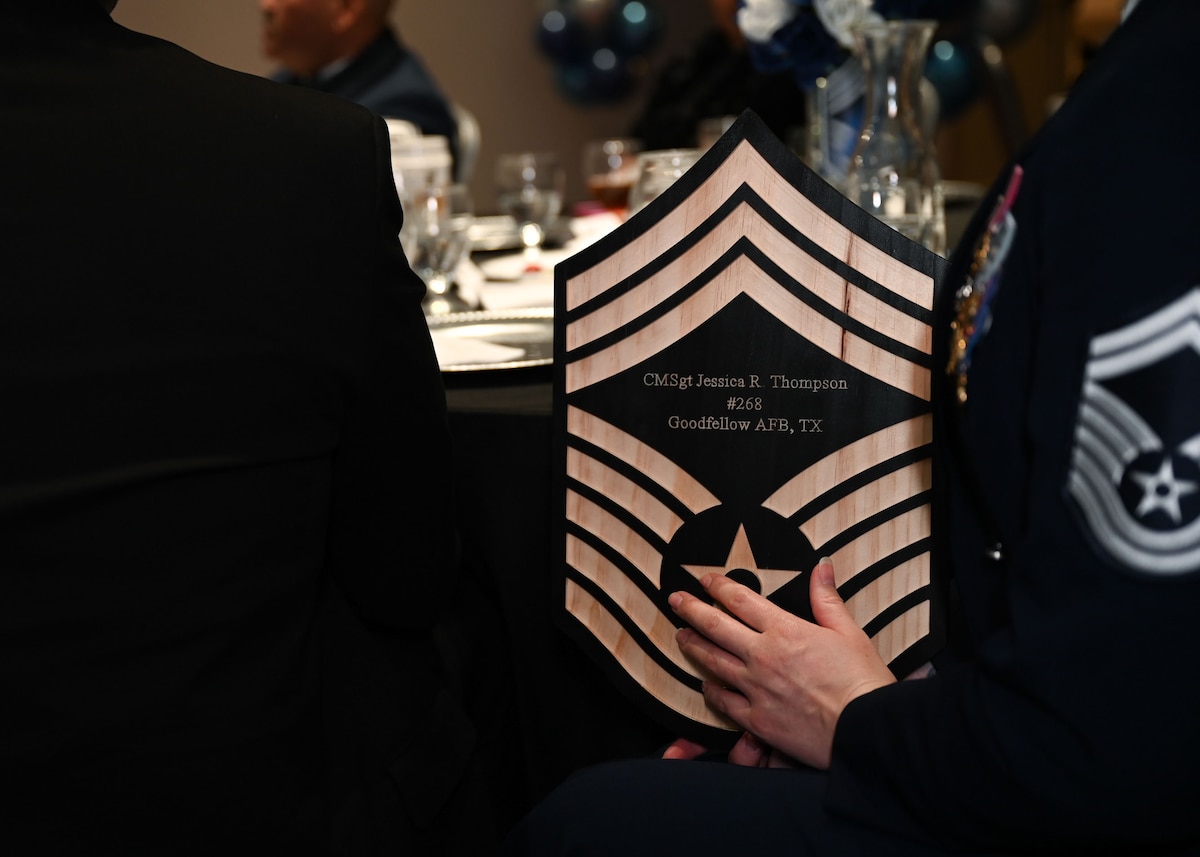 U.S. Air Force Chief Master Sgt. select Jessica Thompson, 17th Force Support Squadron senior enlisted leader, holds her plaque in her hands during the 2025 Chief Master Sergeant Recognition Ceremony in the Powell Event Center at Goodfellow Air Force Base, Texas, March 14, 2025. Thompson was accompanied by her husband and two sons at the event. (U.S. Air Force photo by Senior Airman Evelyn J. D’Errico)