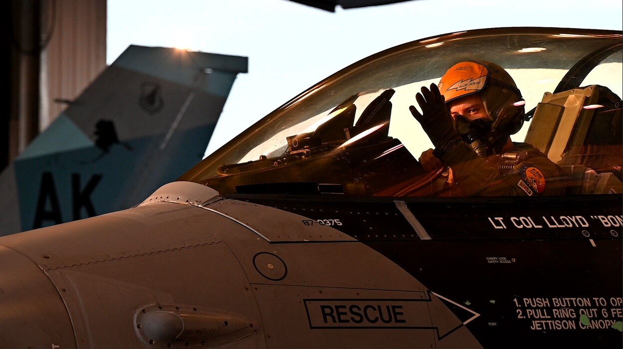 U.S. Air Force Capt. Denver Lennon, 18th Fighter Interceptor Squadron pilot, puts on gloves prior to takeoff at Eielson Air Force Base, Alaska