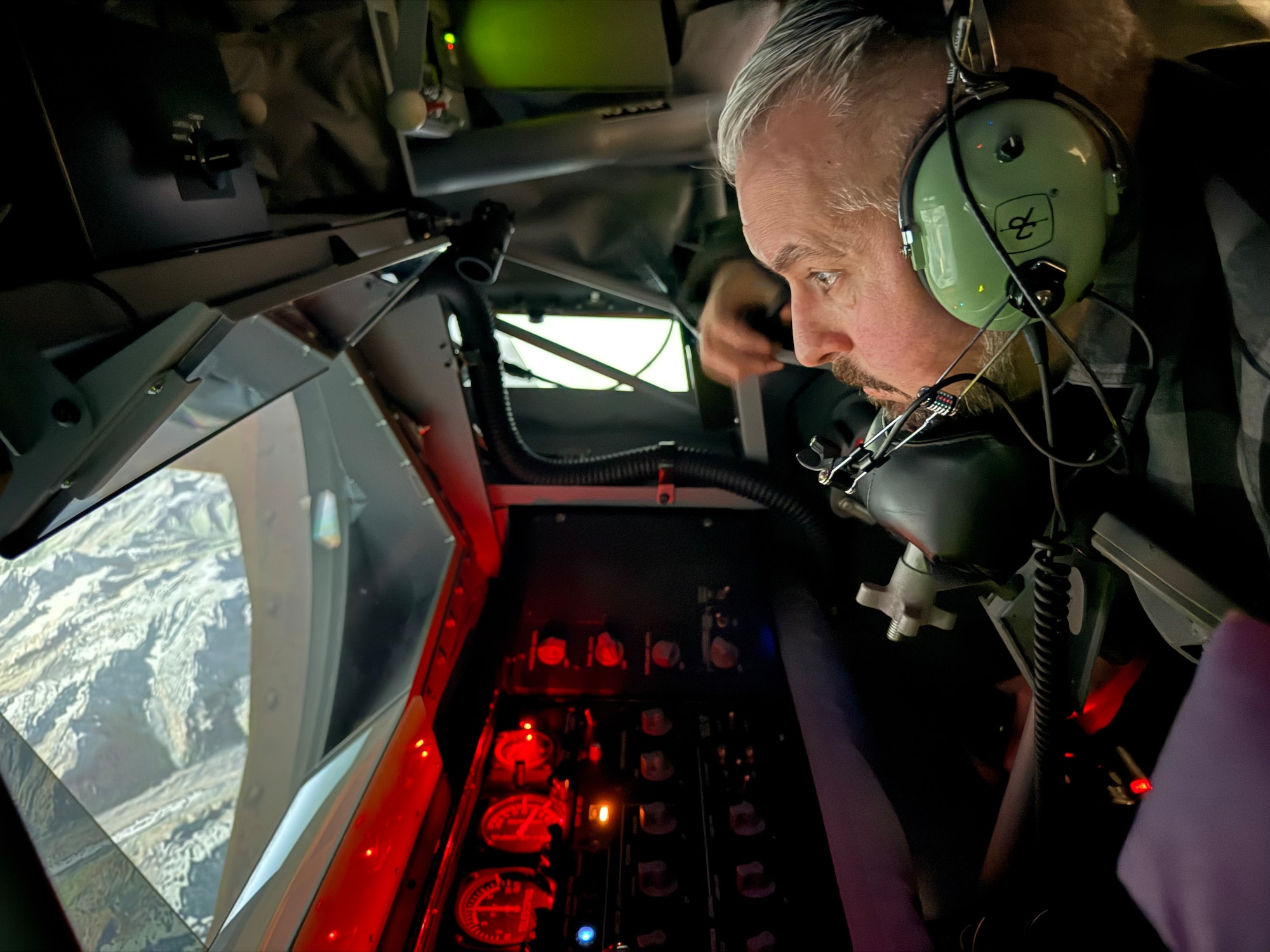 North Pole Mayor Larry Terch experiences air refueling operations with Master Sgt. Pete Gardella, 168th Wing boom operator, as his instructor on the air KC-135 air refueling simulator.