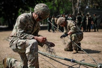 U.S. Army Pfc. Bernardo Gurrola, a radio telephone operator with the 1st Battalion, 3rd Field Artillery Regiment, 17th Field Artillery Brigade, unravels cable in a communication tower setup simulation for the Royal Thai Army during Hanuman Guardian 25 (HG25) on March 13, 2025.