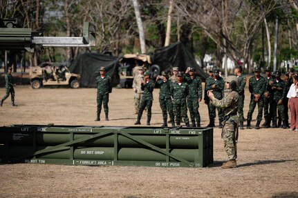 U.S. Army Staff Sgt. Zachary Tenaro, the High Mobility Artillery Rocket System (HIMARS) crew chief with the 1st Battalion, 3rd Field Artillery Regiment, 17th Field Artillery Brigade, demonstrates a HIMARS ammunition reload for the Royal Thai Army during Hanuman Guardian 25 (HG25) in Lop Buri, Thailand on March 13, 2025.