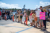 Joint Base Pearl Harbor-Hickam, Hawaii, March 16, 2025 – Friends and family of Sailors assigned to the Virginia-class fast-attack submarine USS Vermont (SSN 792) watch as the submarine returns to Joint Base Pearl Harbor-Hickam, Hawaii after a scheduled deployment, March 16, 2025.
