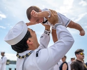 Joint Base Pearl Harbor-Hickam, Hawaii, March 16, 2025. Machinist's Mate, Nuclear Power, 2nd Class Chris Gailiatabarez plays with his son after the Virginia-class fast-attack submarine USS Vermont (SSN 792) returned to Joint Base Pearl Harbor-Hickam, Hawaii following a scheduled deployment, March 16, 2025. Vermont is the third U.S. Navy ship named after the Green Mountain State.