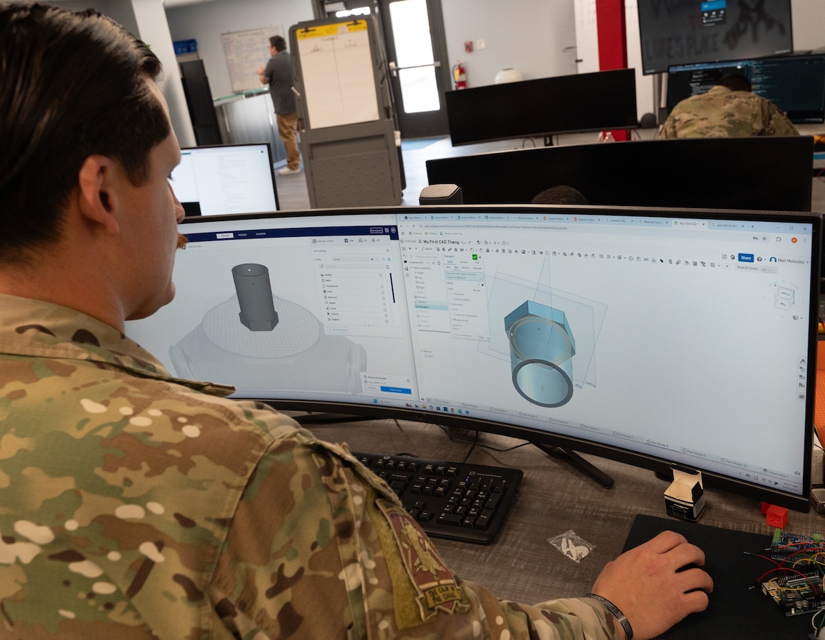 An Airman displays a prototype design on a computer monitor.