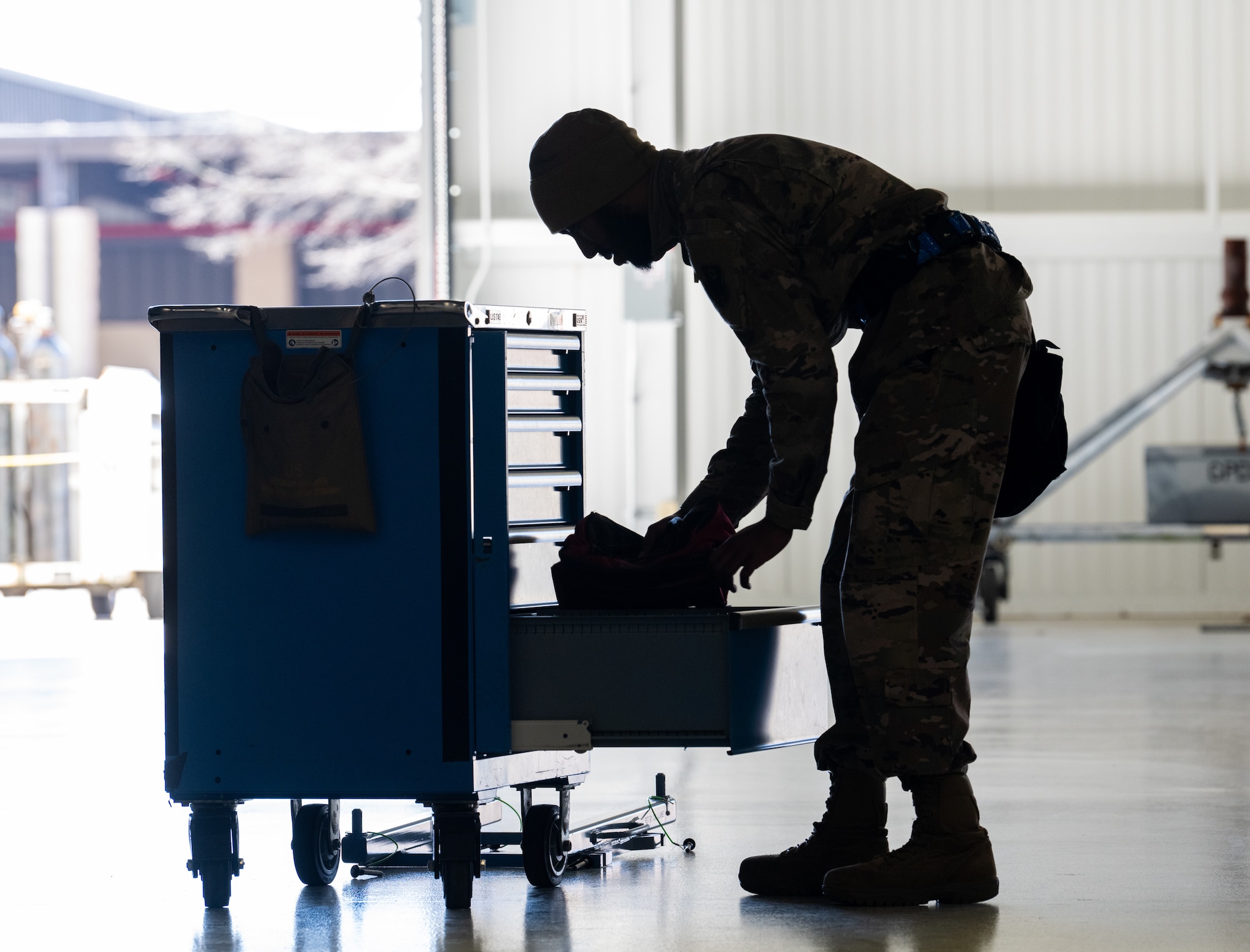 Airmen looks through tool box