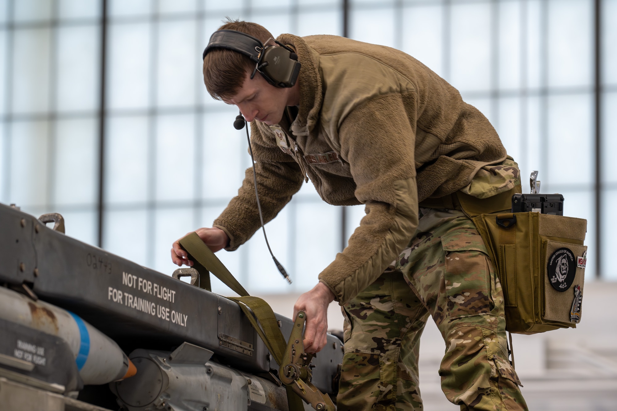 An Airman secures munitions during a load crew competition.