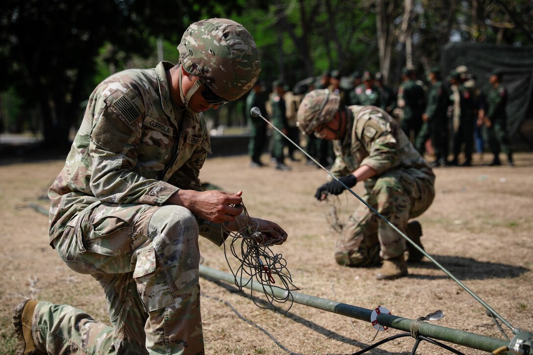 U.S. Army Pfc. Bernardo Gurrola, a radio telephone operator with the 1st Battalion, 3rd Field Artillery Regiment, 17th Field Artillery Brigade, unravels cable in a communication tower setup simulation for the Royal Thai Army during Hanuman Guardian 25 (HG25) on March 13, 2025.