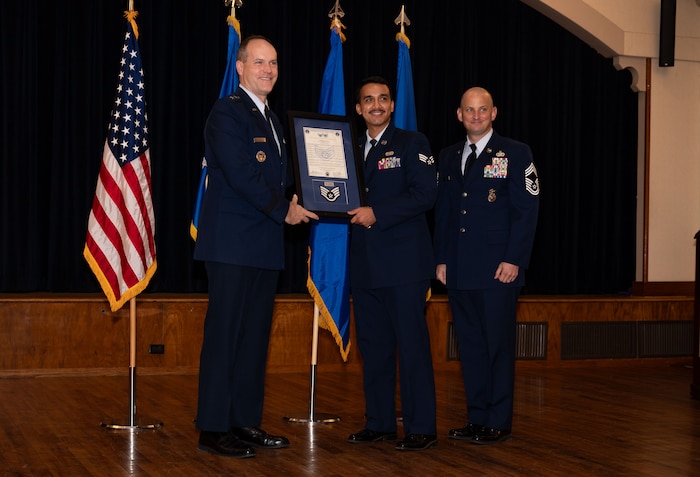 Staff Sgt. Michael Arumugam (center), Air Force Personnel Center and assistant noncommissioned officer-in-charge, receives his certificate of promotion during a noncommissioned officer ceremony at the Joint Base San Antonio-Randolph Parr Club, Jan. 31, 2025.