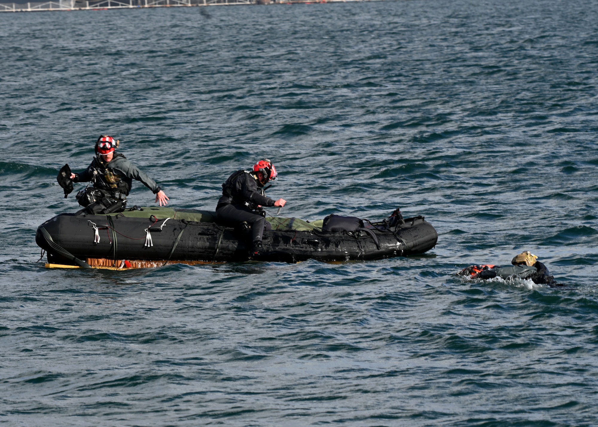 U.S. Airmen assigned to the 38th Rescue Squadron swim to their rescue supplies during Exercise Bamboo Eagle 25-1, in the San Diego Bay, California, Feb. 14, 2025. Bamboo Eagle is a U.S. Air Force Warfare Center exercise that builds upon the tactical expertise exercised in previous exercises and presents participants with opportunities to address challenges associated with mission generation and command and control in a contested environment. This scenario was built by the 414th Combat Training Squadron Detachment 1 from Davis-Monthan Air Force Base, Arizona. (U.S. Air Force photo by Staff Sgt. Abbey Rieves)