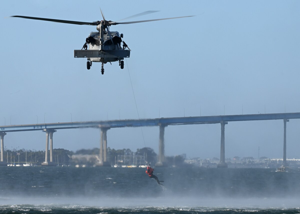 A U.S. Navy MH-60S SeaHawk helicopter assigned to the Helicopter Sea Combat Squadron 8 extracts two pararescue U.S. Airmen during Exercise Bamboo Eagle 25-1, from the San Diego Bay, California, on Feb. 14, 2025. BE is a multinational military training exercise involving over 10,000 service members from the U.S. Department of Defense, Royal Canadian Air Force, Royal Australian Air Force and Royal Air Force, operating, commanding and controlling, maintaining, and supporting more than 150 aircraft at over 15 locations. (U.S. Air Force photo by Staff Sgt. Abbey Rieves)