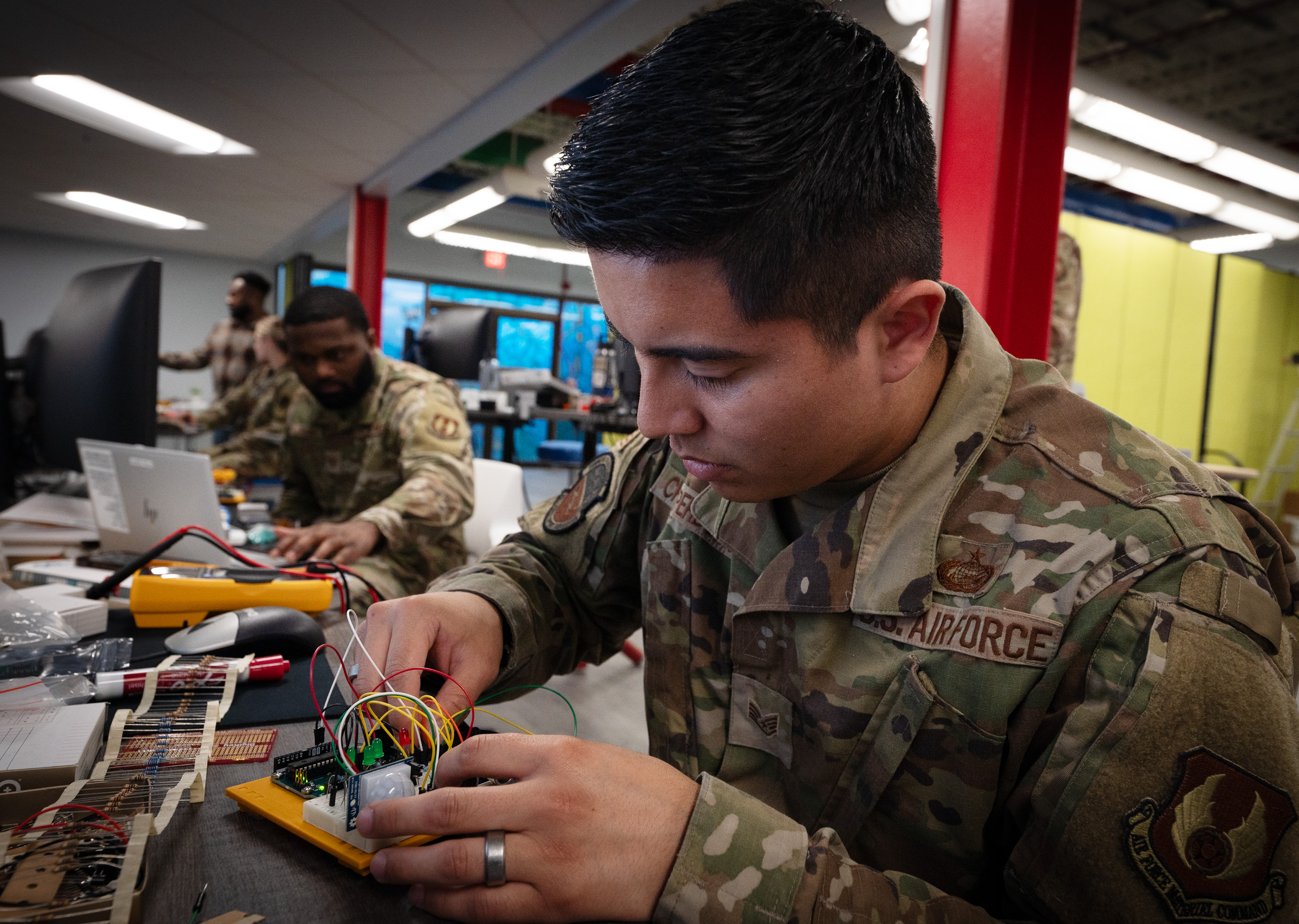 U.S. Air Force Staff Sgt. Luilly Cruz Perdomo, 96th Force Support Squadron supervisor, connects resistors to a circuit board during the first-ever Combat Innovation Cohort workshop at Eglin Air Force Base, Fla., March 12, 2025. The workshop gave Airmen hands-on experience with modular equipment, coding, and 3D printing–skills designed to meet mission needs faster than traditional acquisition processes allow. (U.S. Air Force photo by Michelle Gigante)