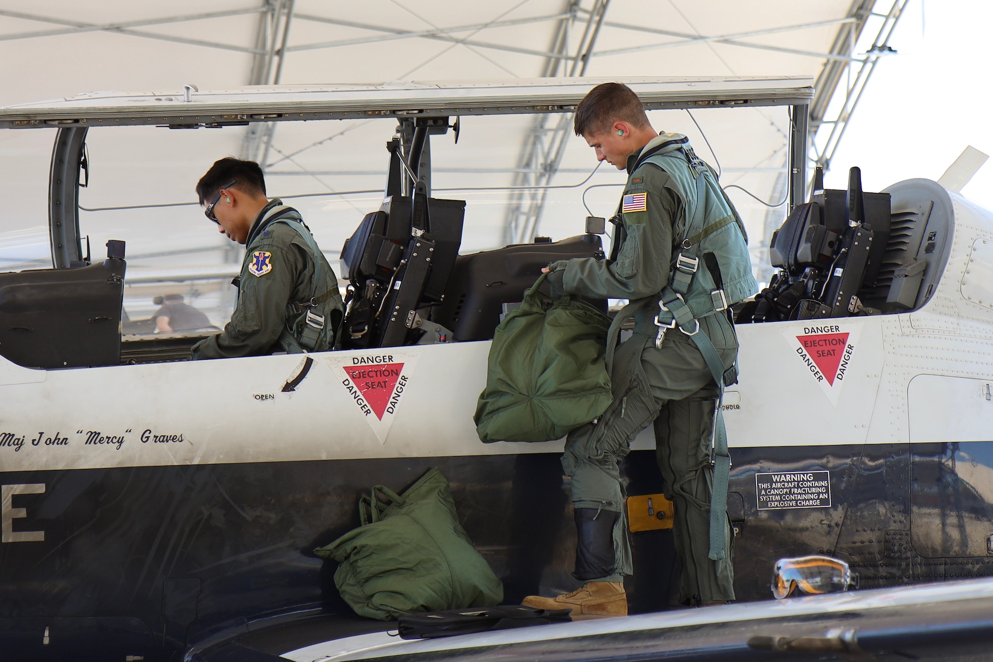 U.S. Air Force Lieutenant Col. Roy Calilung (left), 455th Flying Training Squadron combat systems operator instructor, and 2nd Lieutenant Claas McCrae (right), 455th FTS CSO student, conduct preflight checks on a T-6 Texan II March 6, 2025, at Naval Air Station Pensacola, Florida.