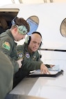 U.S. Air Force Captain Nathan Hallam, 479th Flying Training Group combat systems operator instructor, teaches 2nd Lieutenant John Chambers, 479th FTG CSO student, during the advance phase of training March 5, 2025, at Naval Air Station Pensacola, Florida.