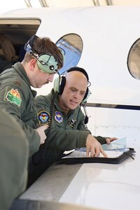 U.S. Air Force Captain Nathan Hallam, 479th Flying Training Group combat systems operator instructor, teaches 2nd Lieutenant John Chambers, 479th FTG CSO student, during the advance phase of training March 5, 2025, at Naval Air Station Pensacola, Florida.