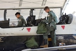 U.S. Air Force Lieutenant Col. Roy Calilung (left), 455th Flying Training Squadron combat systems operator instructor, and 2nd Lieutenant Claas McCrae (right), 455th FTS CSO student, conduct preflight checks on a T-6 Texan II March 6, 2025, at Naval Air Station Pensacola, Florida.