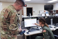 U.S. Air Force Major Philip Gommesen, 479th Flying Training Group combat systems operator instructor, briefs 2nd Lieutenant Clare Provoncha, 479th FTG CSO student, during the advance phase of training March 5, 2025, at Naval Air Station Pensacola, Florida.