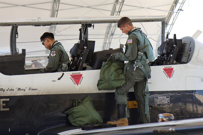 U.S. Air Force Lieutenant Col. Roy Calilung (left), 455th Flying Training Squadron combat systems operator instructor, and 2nd Lieutenant Claas McCrae (right), 455th FTS CSO student, conduct preflight checks on a T-6 Texan II March 6, 2025, at Naval Air Station Pensacola, Florida.