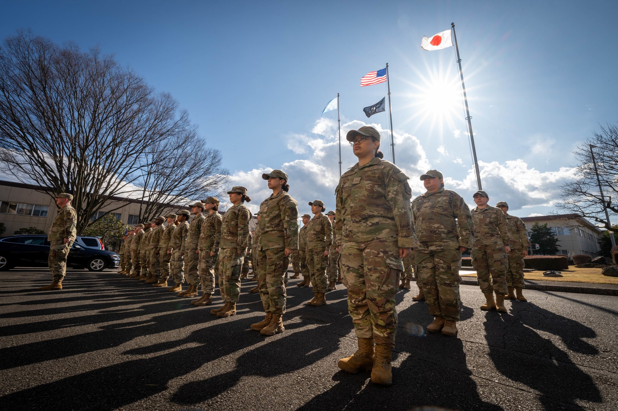 Airmen from the 374th Airlift Wing stand at attention.