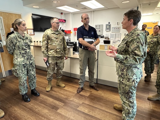 GUANTANAMO BAY, Cuba (Feb. 27, 2025) – From left, U.S. Navy Capt. Heather Grote, chief medical officer of U.S. Naval Station Guantanamo Bay, Office of the Assistant Secretary of Defense for Health Affairs; Brig. Gen. John Andrus, Joint Staff Surgeon; and Dr. Stephen Ferrara, Acting Assistant Secretary of Defense for Health Affairs, listen as U.S. Navy Capt. Tammy Servies, director of U.S. Naval Hospital Guantanamo Bay, provides a tour of the emergency department. Servies and members of her Executive Steering Committee guided the tour to showcase the hospital’s departments and capabilities to Ferrara and his delegation. (U.S. Navy photo by Emily McCamy)