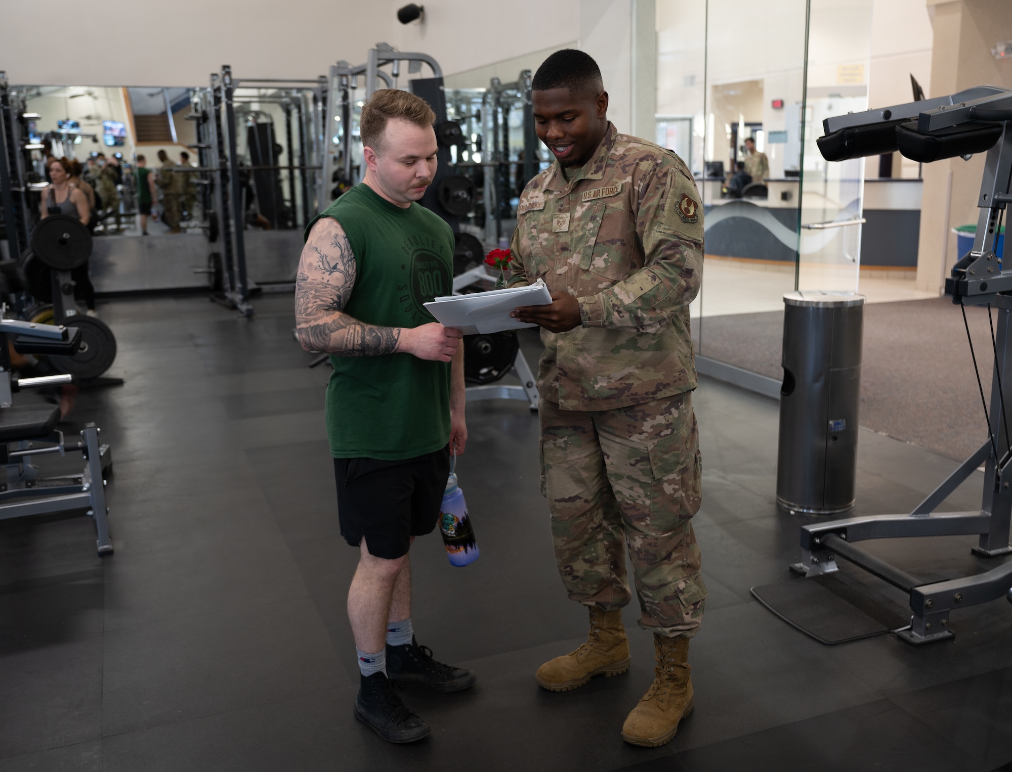 Airman signs a paper next to Airman. (U.S. Air Force Photo by Airman 1st Class Donnell Ramsey)