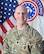 Male Soldier head and shoulders photo in front of United States National and US Army Recruiting Command flags