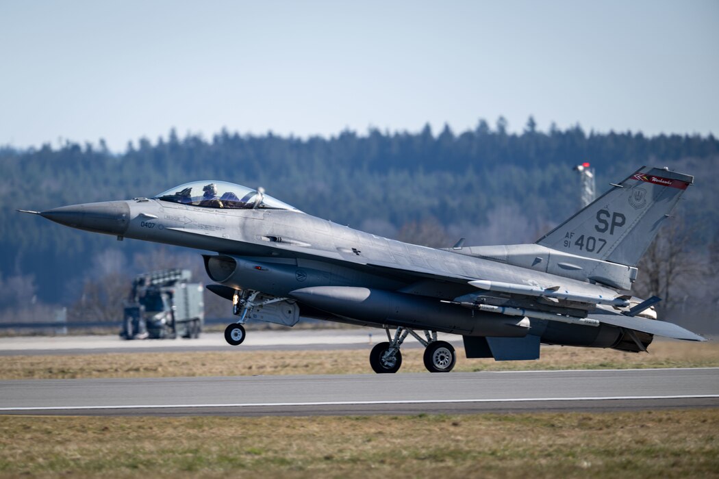 An F-16 Fighting Falcon lands on a run way.