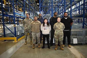U.S. Air Force service members and logistical support members assigned to the integrated personnel equipment section of the 11th Logistics Readiness Squadron gather for a photo in Hangar 1 at Joint Base Anacostia-Bolling in Washington, D.C., March 18, 2025. This team spearheaded the opening of the base’s first deployment armory which furthers JBAB’s mission readiness. (U.S. Air Force Photo by Airman 1st Class Shanel Toussaint)