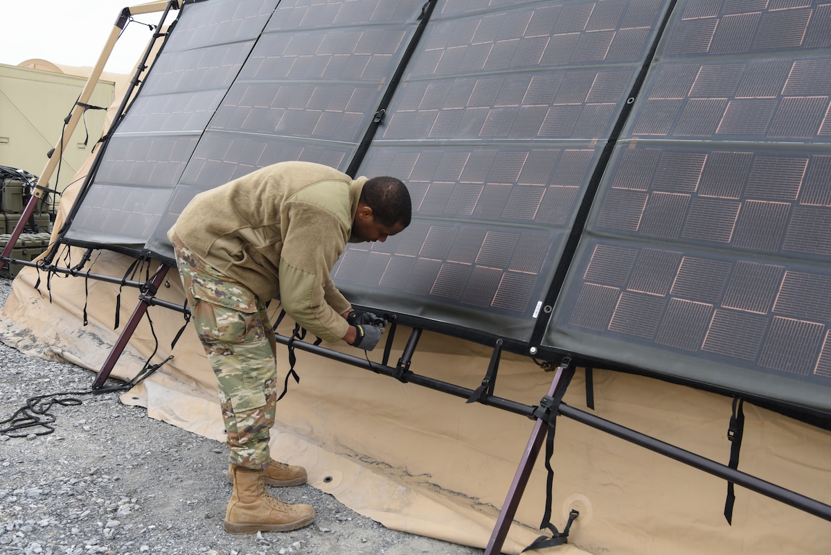 Airman working on solar panel