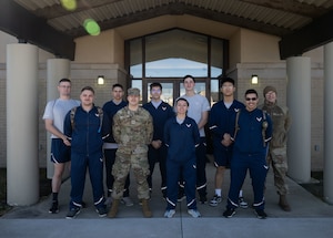 Team Dover Airmen stand for a photo after Bay Orderly at Dover Air Force Base, Delaware, March 18, 2025. Bay Orderly is a program for new Airmen to help keep the dorms clean and in good condition every week. (U.S. Air Force photo by Airman 1st Class Liberty Matthews)