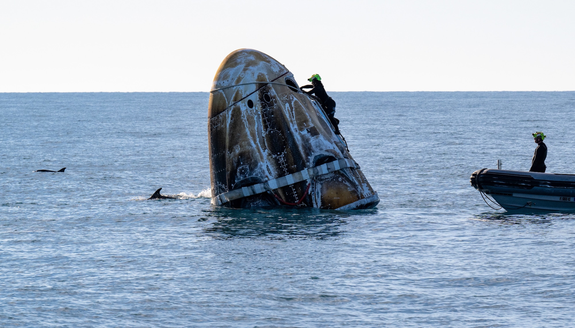 An astronaut lands in the water.