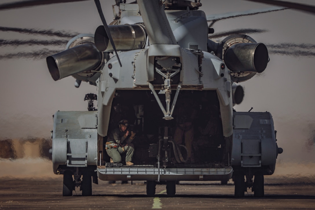 U.S. Marine Corps Sgt. Makayla Elizalde, an Abilene, Texas native, combat videographer with Communication Strategy and Operations, A. Company, Headquarters Battalion, collects imagery aboard a CH-53K King Stallion helicopter during Marine Air-Ground Task Force Distributed Maneuver Exercise 1-25 at Camp Willson, Marine Corps Air-Ground Combat Center, Twentynine Palms, California, Feb. 11, 2025. MDMX prepares Marines for future conflicts by combining constructed virtual training with offensive and defensive live-fire and maneuver training scenarios. Service Level Training Exercise 1-25 is designed to enhance readiness across core Mission Essential Tasks and prepares the MAGTF to execute distributed operations across vast, diverse environments by emphasizing decentralized command and control. (U.S. Marine Corps photo by Staff Sgt. Armando Elizalde)