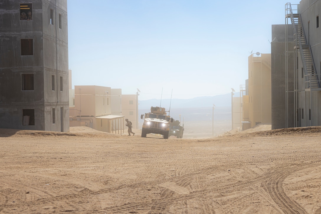 A U.S. Marine with 2nd Battalion, 23rd Marine Regiment, 4th Marine Division, moves gear onto a Humvee during urban company defense as part of Service Level Training Exercise 1-25 at Range 220, Marine Corps Air-Ground Combat Center, Twentynine Palms, California, Feb. 4, 2025. Through realistic scenarios and decentralized decision-making, Integrated Training Exercise provides Marines the venue to enhance their lethality by empowering leaders at every level to adapt, communicate, and execute in dynamic environments. ITX is part of the Service-Level Training Exercise Program provided by Marine Air-Ground Task Force Training Command through a cadre of instructors committed to developing high-caliber Marines. (U.S. Marine Corps Photo by Lance Cpl. Enge You)