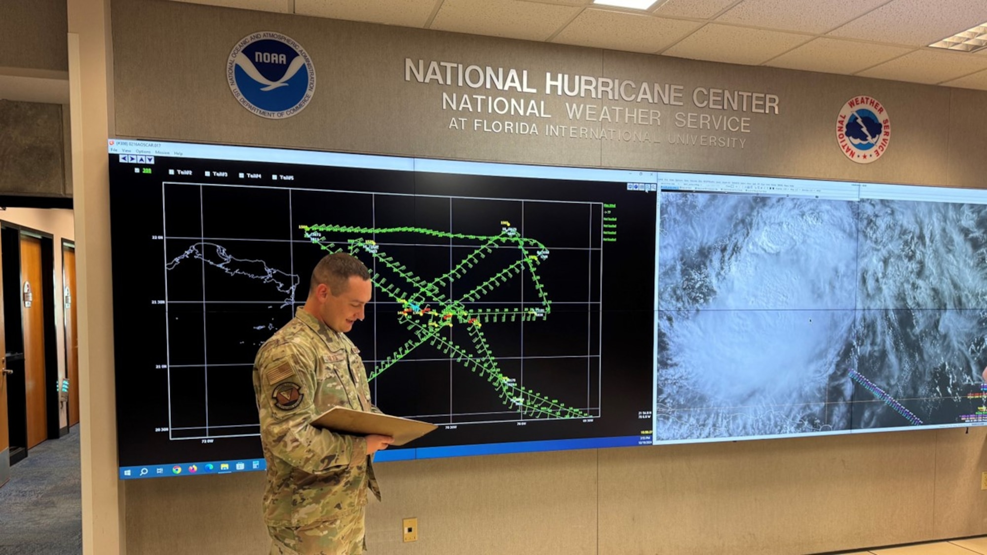 Airman gives a weather briefing at the National Hurricane Center.
