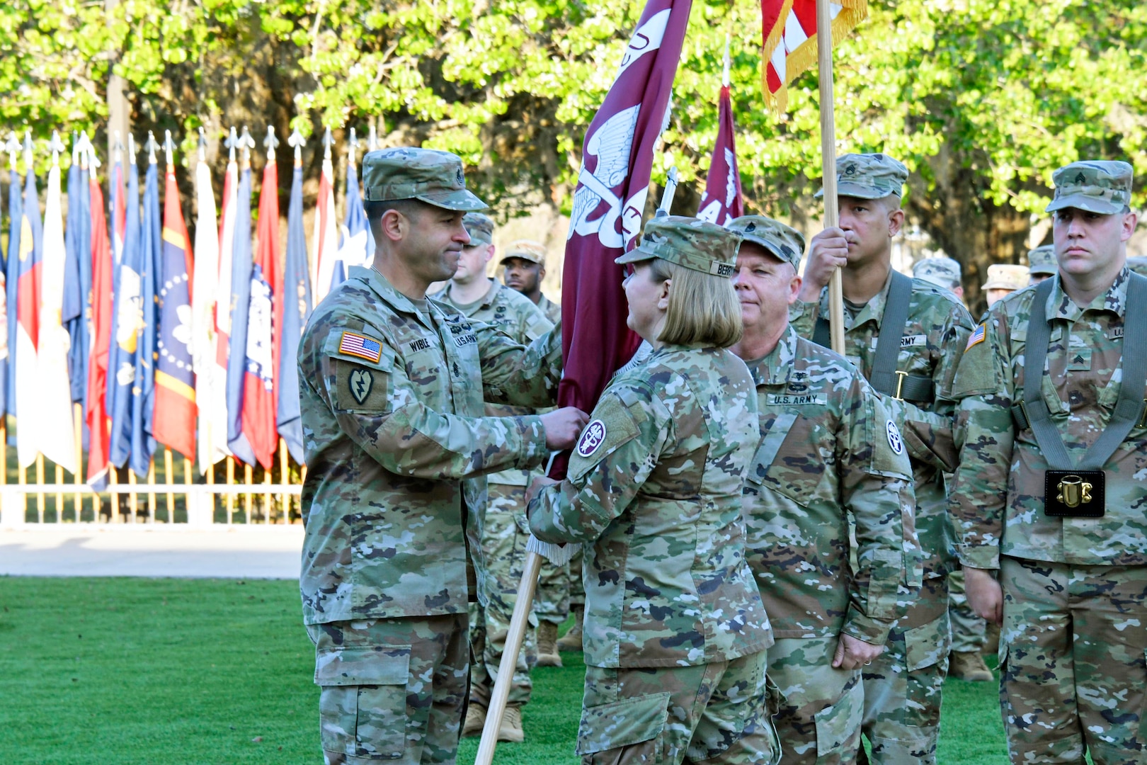 Col. Margaret Berryman, Fort Stewart U.S. Army Medical Department Activity commander and Winn ACH director passes the unit’s colors to Command Sgt. Maj. Mario Wible March 19 as he assumes responsibility of the MEDDAC and the hospital as its senior enlisted advisor during a ceremony at Fort Stewart’s Cashe Garden.