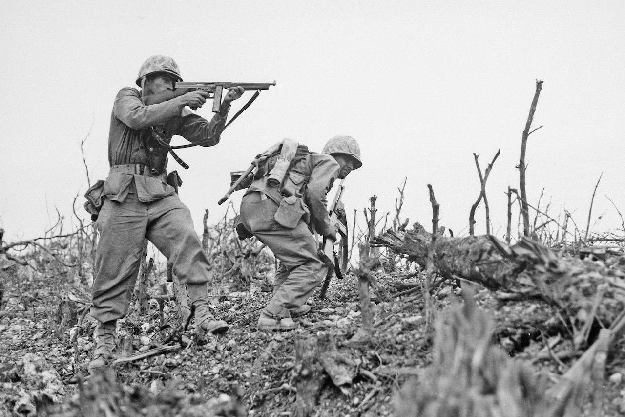 Two men wearing camouflage uniforms and holding weapons stand ready to attack an enemy.