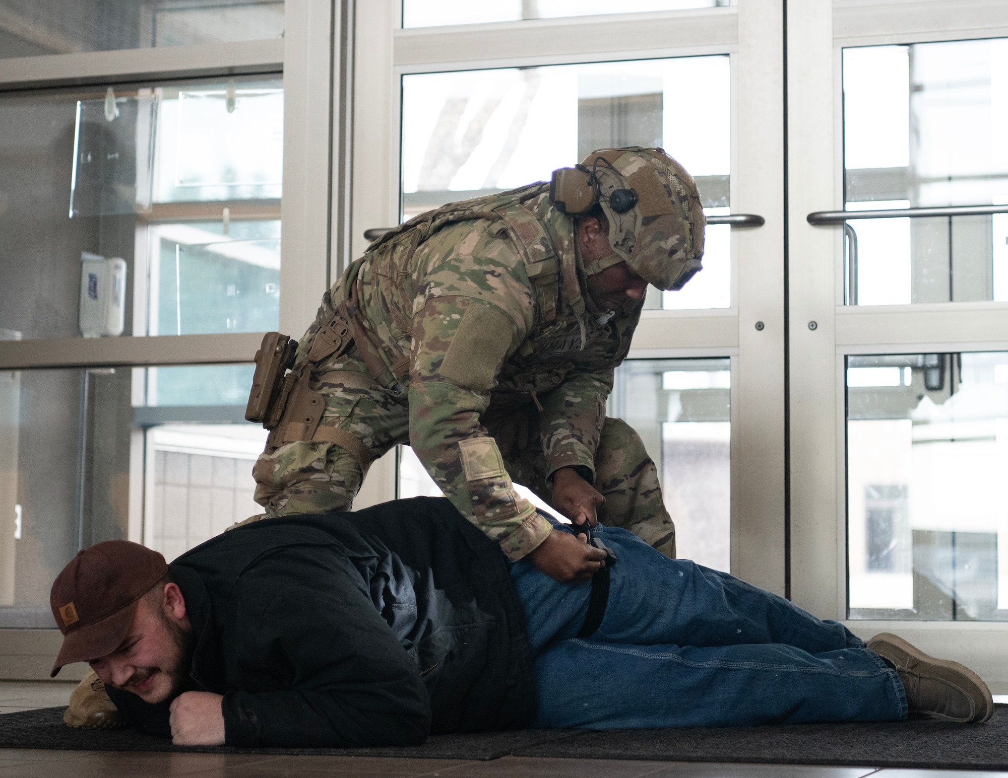 U.S. Air Force Airman from the 133rd Security Forces Squadron applies a tourniquet onto a role player building during an active shooter exercise in St. Paul, Minn., March 3, 2025.