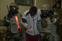 U.S. Air Force Senior Airman Zaria Berrios, left, 35th Force Support Squadron (FSS) force management technician, and Airman 1st Class Gabrielle Gray, right, 35th FSS customer support technician, carry a casualty actor during Beverly Sunrise 25-03.