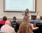 A woman briefs an audience