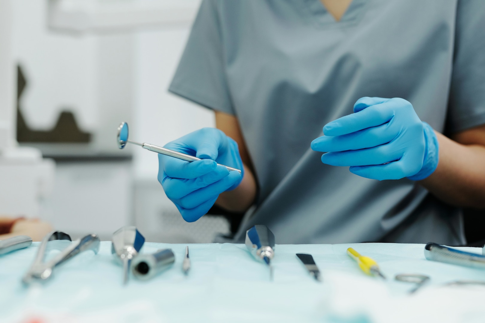 Dentist holds dental equipment.