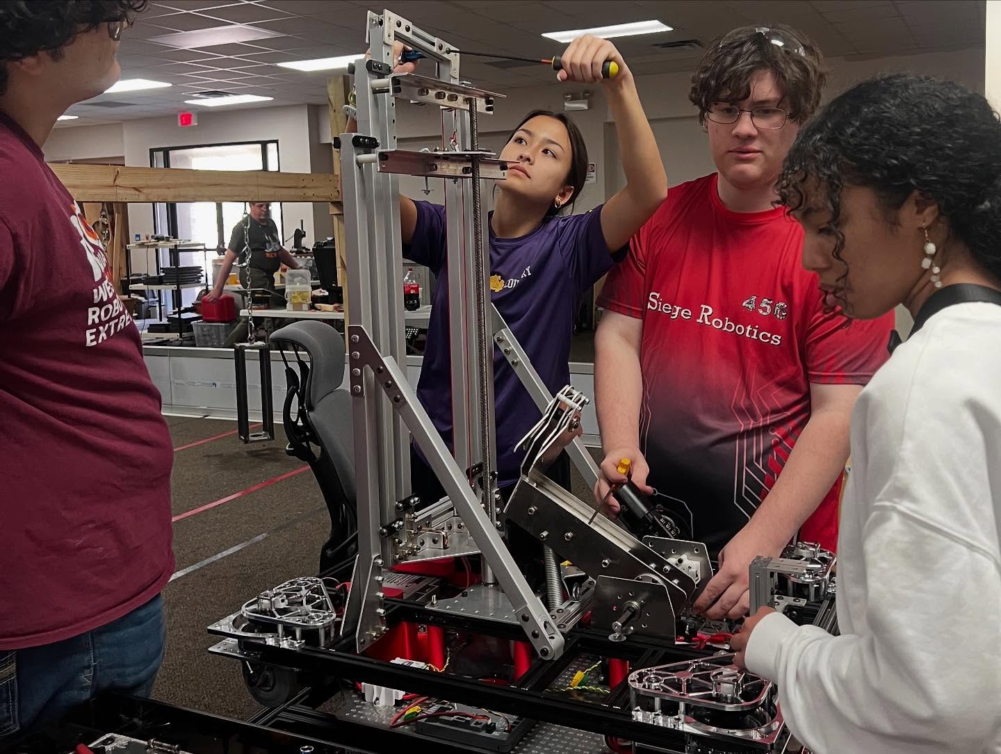 FRC team members work on robot for competition.