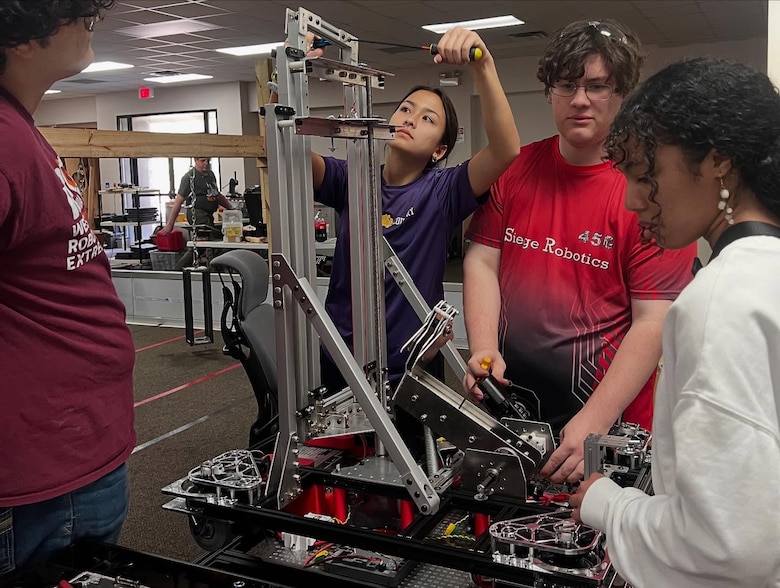 FRC team members work on robot for competition.