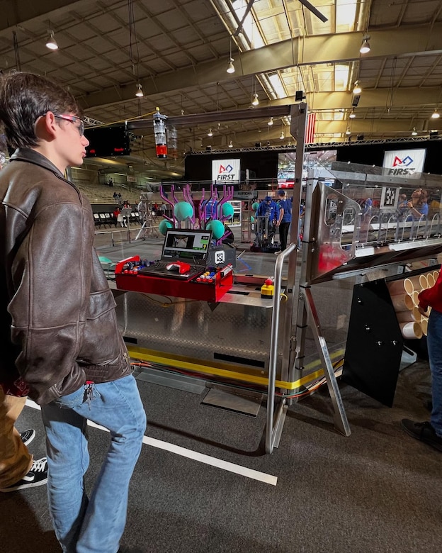 FRC Team member observes robot during challenge at regionals.