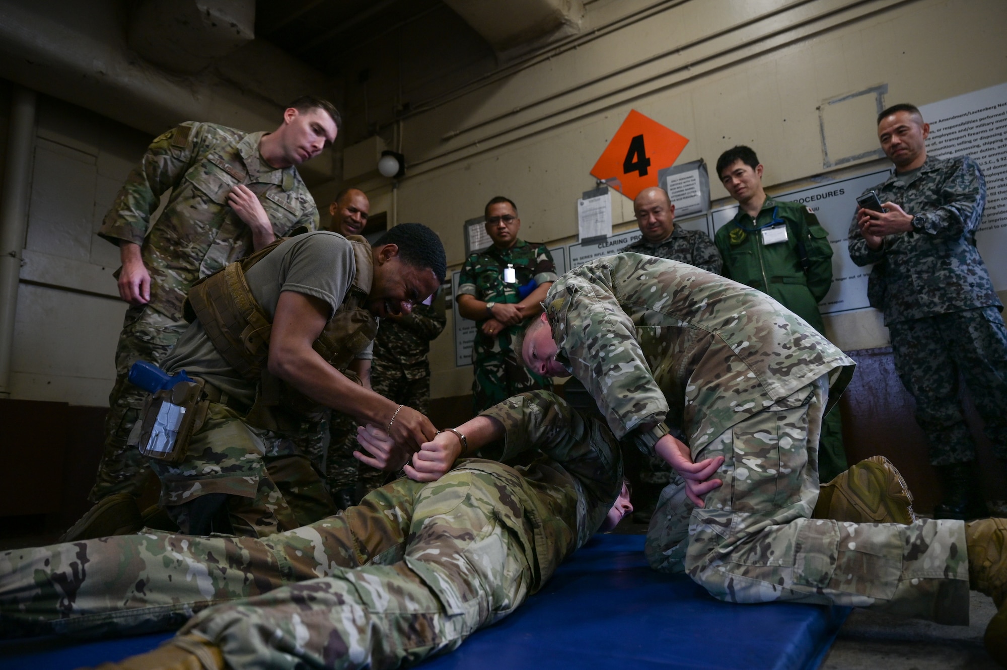 An U.S. Airman demonstrates apprehension techniques while under the effects of pepper spray.