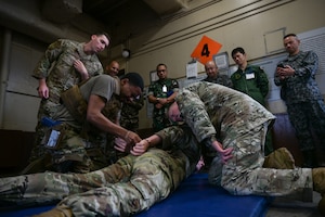 An U.S. Airman demonstrates apprehension techniques while under the effects of pepper spray.