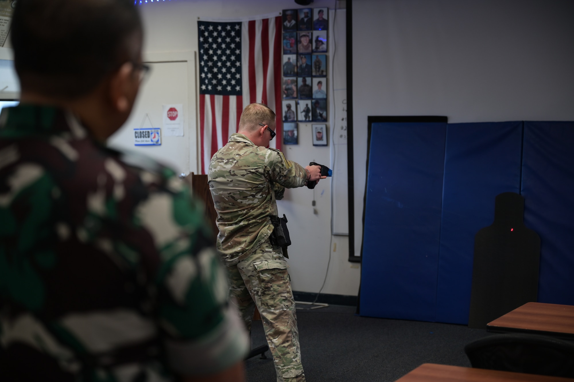 A U.S. Air Force military policeman shows foreign visitors how to use a taser.