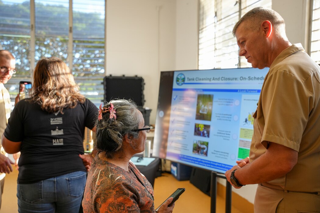 The Navy Closure Task Force-Red Hill (NCTF-RH) deputy director of facilities speaks with a guest during the NCTF-RH open house held at the Keʻehi Lagoon Memorial in Honolulu, March 12, 2025. NCTF-RH hosted the open house for members of the community to learn more about current and future efforts of the Red Hill Bulk Fuel Storage Facility (RHBFSF) closure, tank cleaning, and drinking water monitoring. Charged with the safe decommissioning of the facility, NCTF-RH was established by the Department of the Navy as a commitment to the community and the environment, and continues to engage with the people of Hawaii, regulatory agencies, and other stakeholders as it safely and deliberately decommissions the RHBFSF. (U.S. Navy photo by Mass Communication Specialist Seaman Krystal Diaz)