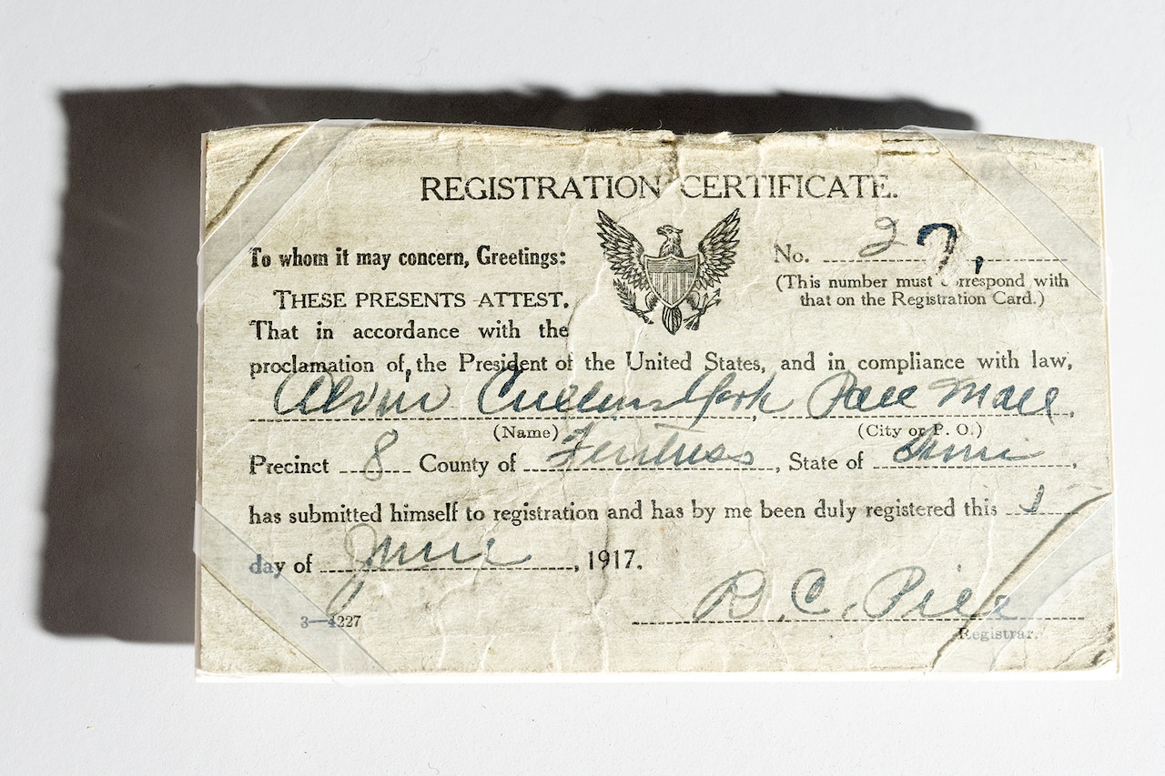 A white sheet of paper reads, “registration certificate,” among other words.