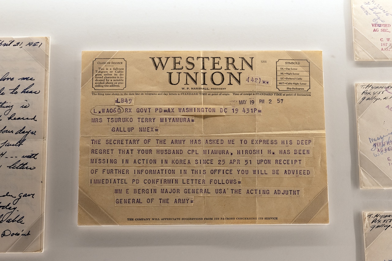 A yellowing Western Union telegram sits in a display case.